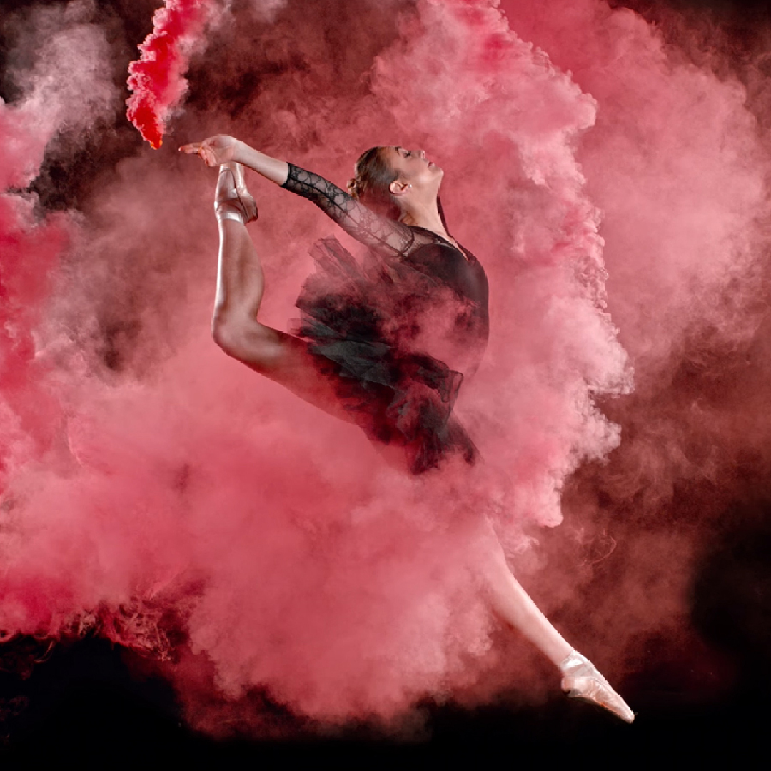 Dancer surrounded by pink smoke